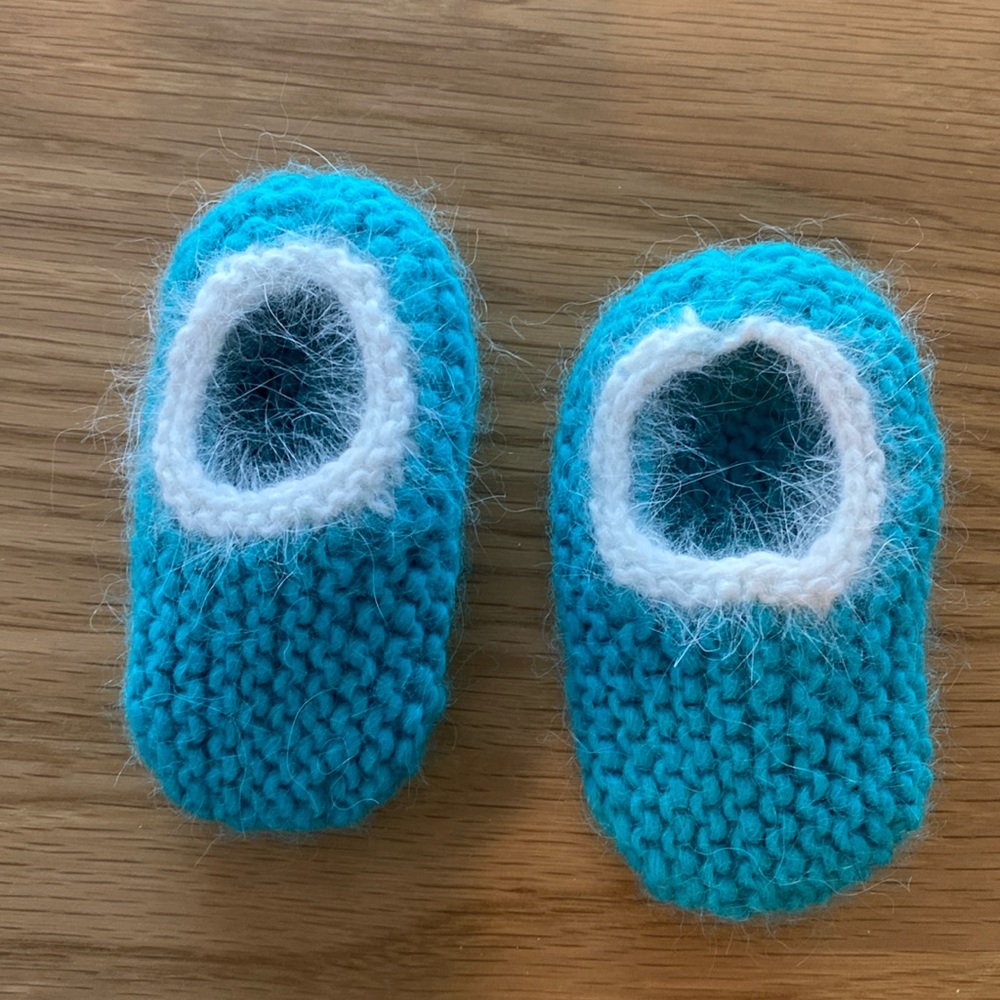 Baby booties in teal with white mohair trim. 3-4 inches long. Hand knitted.